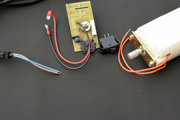 Parts for electric machine, motor, pcb, wires, potentiometer, switch. Horizontal image with copy space.