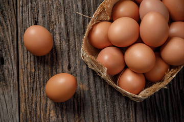 Egg in a basket on wooden table, Chicken Egg