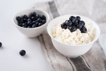 Cottage cheese with blueberries on wood