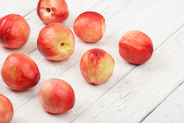 Ripe red peaches on the white wooden table
