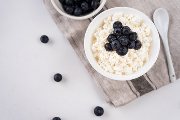 Cottage cheese with blueberries on wood