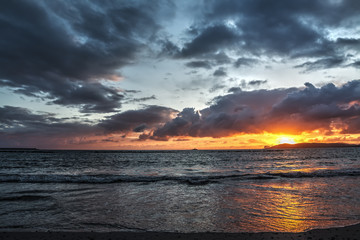 Shining sun and dark sky at sunset