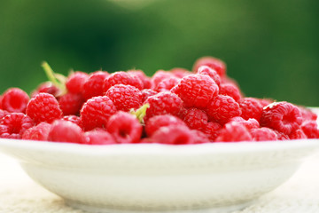 white plate with raspberry