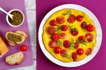 omelette with sausages, pesto sauce, bread