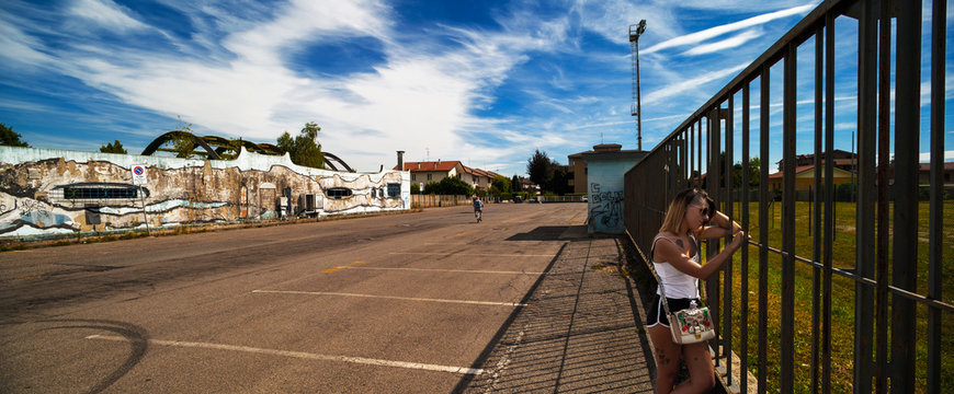 Young woman watch abandoned sport center