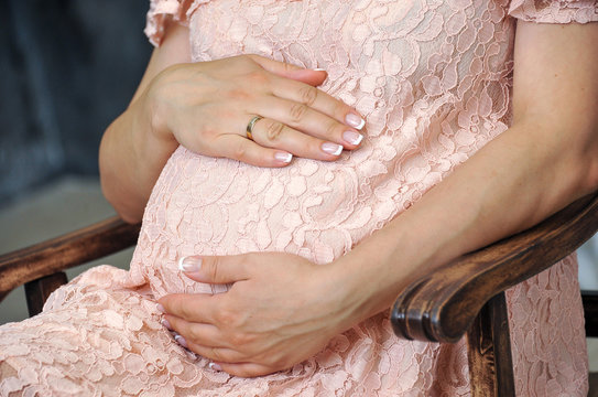 Take care of your body. The concept of a pregnancy diet. Female hands.