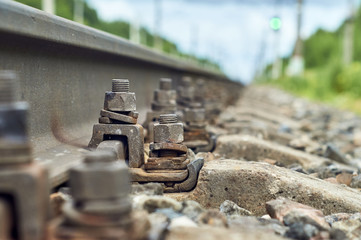 Low angle view of the screws fixing railroad rail close up