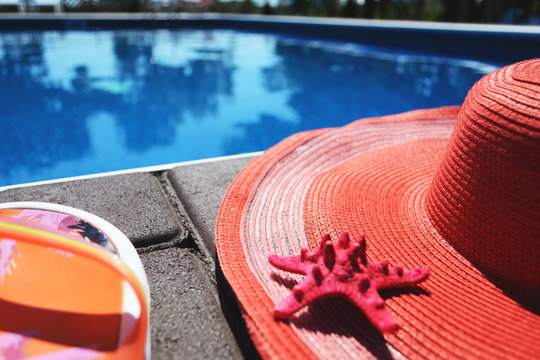 Summer accessories (hat, slaps) near the pool. With free blank space for your text.