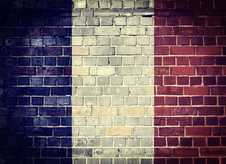 Grunge France flag on a brick wall