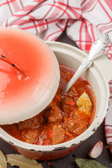 Goulash is a traditional Hungarian dish of stewed beef with vegetables in a thick tomato sauce with spices. Selective focus