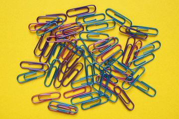 office paper clips on yellow background