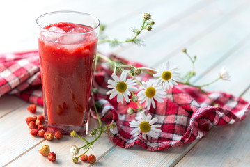 Big glass of homemade smoothie with strawberries
