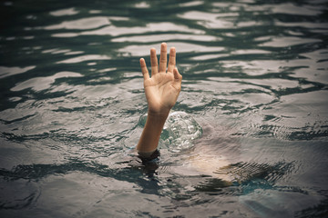 Drowning people raise hands for help in the pool.
