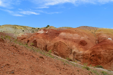 Fototapeta na wymiar Red cliffs of red hills in Altai mountains. Martian landscape. Altay Republic, Russia.