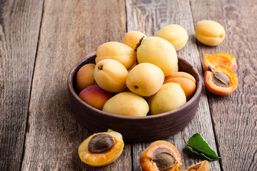 Ripe organic apricots on rustic wooden table