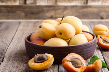 Ripe organic apricots on rustic wooden table