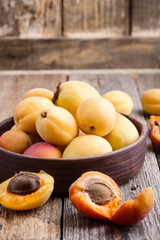 Naklejka na ściany i meble Ripe organic apricots on rustic wooden table