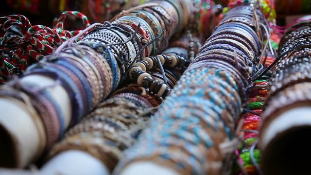 Variety of handmade friendship bracelets sold at local market, accessories