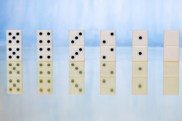Domino pieces with reflection on the table
