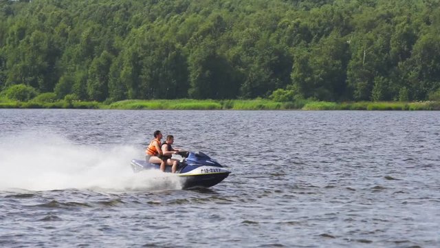 People riding on a jet ski. High speed jetski with water spray. People rid on water scooter. 4k.