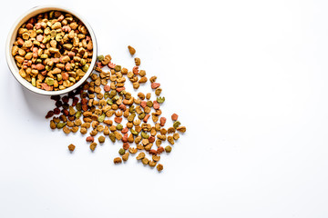 dry cat food in bowl on white background top view