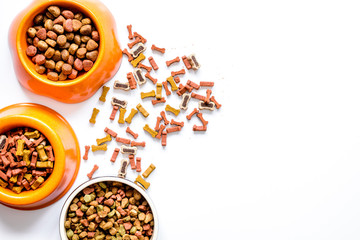 dry dog food in bowl on white background top view