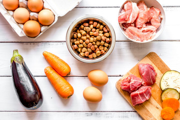 ingredients for pet food holistic top view on wooden background