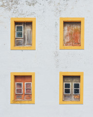Fototapeta na wymiar Lisbon old wall with yellow windows