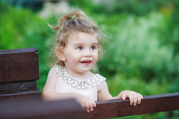 Cute little girl having fun outdoors in the summer park
