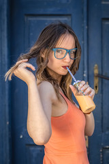 Female drinking smoothie outdoors