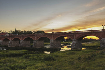 The old-fashioned Latvia.Kuldiga. ventas hub over the bridge at night