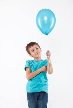 Happy Boy With A Blue Ballon In Studio