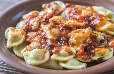 Portion of ravioli with marinara sauce