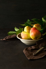 Plate with ripe pears. Low key. Selective focus
