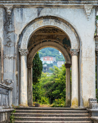 Fototapeta na wymiar View through the old arch of abandoned railway station. Gagra, Abkhazia