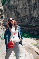 Girl standing near a rock wall