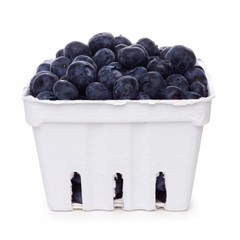 Fresh blueberries in a white paper carton isolated on a white background