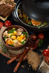 Roast in a clay pot rustic style view from above