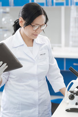 Smart positive biologist checking the equipment