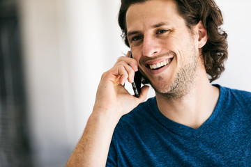 Workspace: Handsome Guy Using Cell Phone In Brightly Lit Hallway