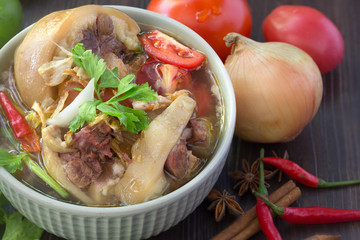 Oxtail soup, halal food, delicious, Muslim food in green bowl on dark brown wooden plate / Selective focus.