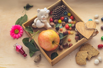 Ripe apple in a wooden box and gift bags