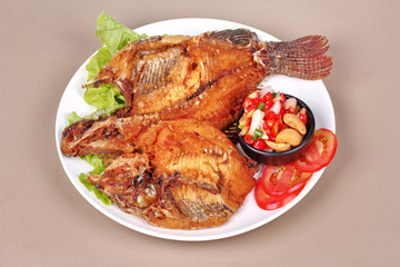 Deep fried Tilapia with spicy and sour herb salad .