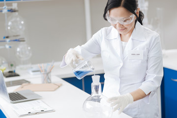 Fototapeta premium Cheerful professional scientists working with reagents