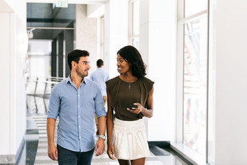 Fototapeta premium Workspace: Business Friends Walk And Talk At Work