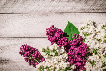 lilac flowers on wooden background. top view with copy space.