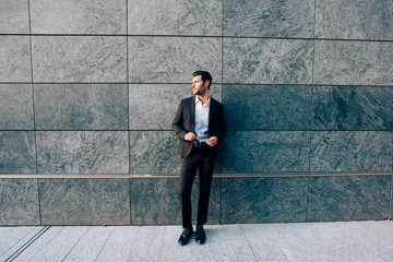 young bearded businessman outdoor posing looking away - ambition, business attire, attitude concept