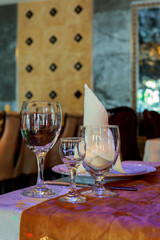 Glasses, flower fork, knife served for dinner in restaurant