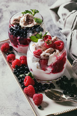 Traditional summer dessert Eton Mess. Broken meringue with whipped cream, berry jam, fresh...