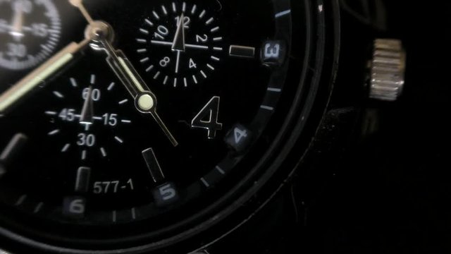 Mens Watch made metal with sapphire glass. Macro video. Time is running out. Close-up of watch with metal  arrows